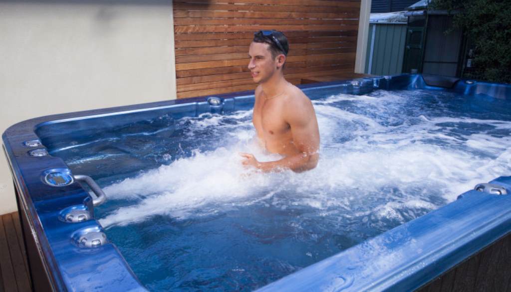 Man soaking in geothermal spa to ease joint pain